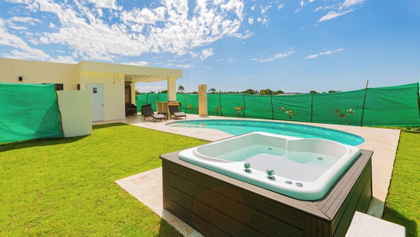 A backyard with a hot tub, a swimming pool, and a covered patio area. - villa mon Fleur w/jacuzzi,free shuttle at casa linda (Sosua)
