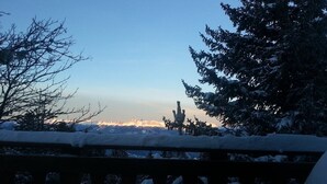 A snowy landscape with a clear sky, a wooden railing, and snow-covered trees. - Unusual chalet, 2 ppl, terrace with mountain view. (Chamrousse)