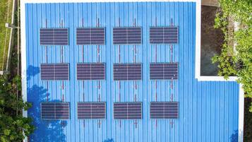 A rooftop with solar panels arranged in a grid pattern.