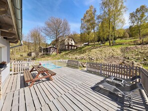 A wooden deck with a pool, a picnic table, and a white fence. - U Dzina by Interhome (Desná v Jizerských horách)