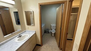A bathroom with a sink, mirror, and toilet. - Apartment Centrally Located (Plymouth)