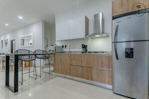 Fridge, microwave, coffee/tea maker, cookware/dishes/utensils