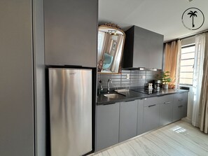 Fridge, coffee/tea maker, cookware/dishes/utensils