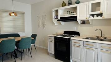 Fridge, microwave, coffee/tea maker, cookware/dishes/utensils