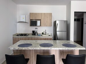 Fridge, microwave, coffee/tea maker, cookware/dishes/utensils