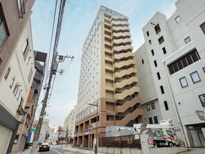 A multi-story building with a modern architectural design, featuring a prominent central staircase and a series of balconies. - Toyoko Inn Tokyo Minowa eki (Tokyo)