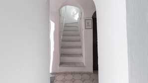 A staircase leading to a landing with a framed sign on the wall. - Typical Ligurian house with garden and sea view terrace (Cipressa)