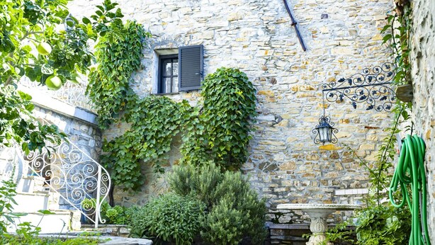 A stone courtyard with a fountain, a window with shutters, and a wall with decorative metalwork. - Typical Ligurian house with garden and sea view terrace (Cipressa)