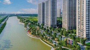 A high-rise residential building complex with a river running alongside. - Moon Homestay 96 (Hanoi)