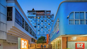 A building with a unique facade featuring a grid of square windows. - B2 Sisaket Boutique & Budget Hotel (Sisaket)