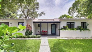 A modern house with a covered patio, a lawn, and a pathway leading to the entrance. - 5 Mi to Beach: Group Getaway w/ Yard in Miami (Miami)