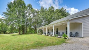 A covered porch with outdoor seating and a gravel driveway. - 11 Mi to Troy University: Family Home w/ Yard (Troy)