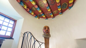 A staircase with a wooden handrail and a decorative ceiling with intricate designs. - Historic 6-Bedrooms Castle Retreat (Cupar)