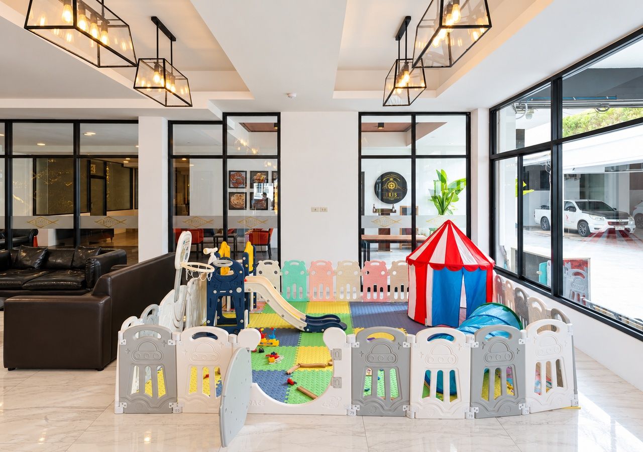 A modern interior with a play area, seating, and large windows.