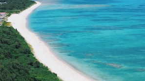 A coastal landscape with a sandy beach and dense greenery. - Mizu to Kaze (Harabaru,Kumejima, Shimajiri,)