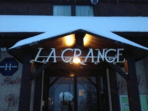 The entrance of La Grange with a sign above the door. - HOTEL LA GRANGE (Boutx)