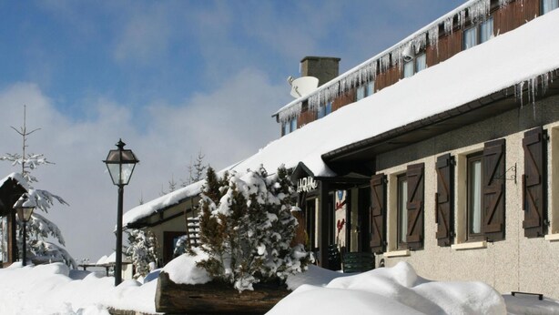A snow-covered building with a sign that reads "LAROM". - HOTEL LA GRANGE (Boutx)