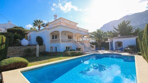 A large, two-story house with a swimming pool in the foreground. - Luxury Villa in Denia with sea views (Denia)