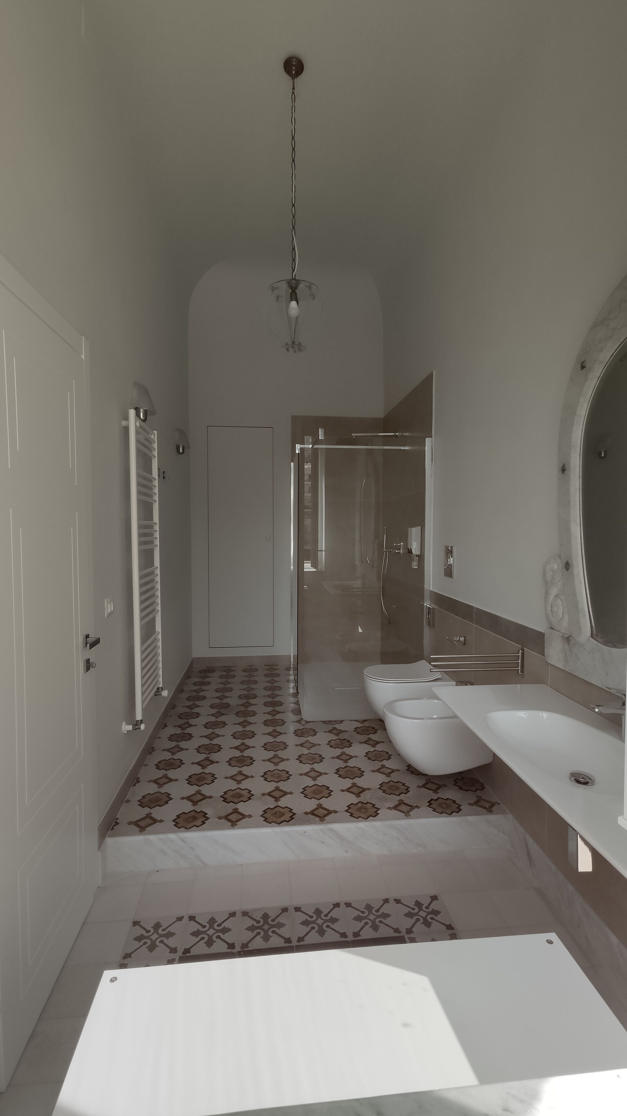 A bathroom with a shower, a toilet, and a sink.