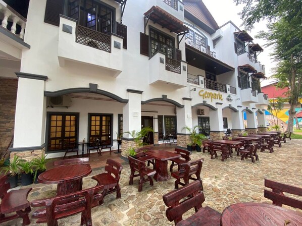 A courtyard with outdoor seating and a building labeled 'Geopark.' - Capital O 91179 Geopark Oriental Village (Langkawi)