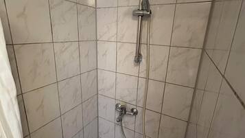 A shower with a handheld showerhead and a handheld hose.
