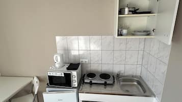 Twin Room | Private kitchen | Fridge, electric kettle, cleaning supplies
