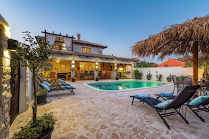 A villa with a swimming pool, lounge chairs, and a patio area. - Villa Andrea Zadarvillas (Nin)