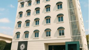 A multi-story hotel with a modern facade, featuring a prominent logo on the lower facade. - Casa Incanto Hotel in Gumi (Gumi)
