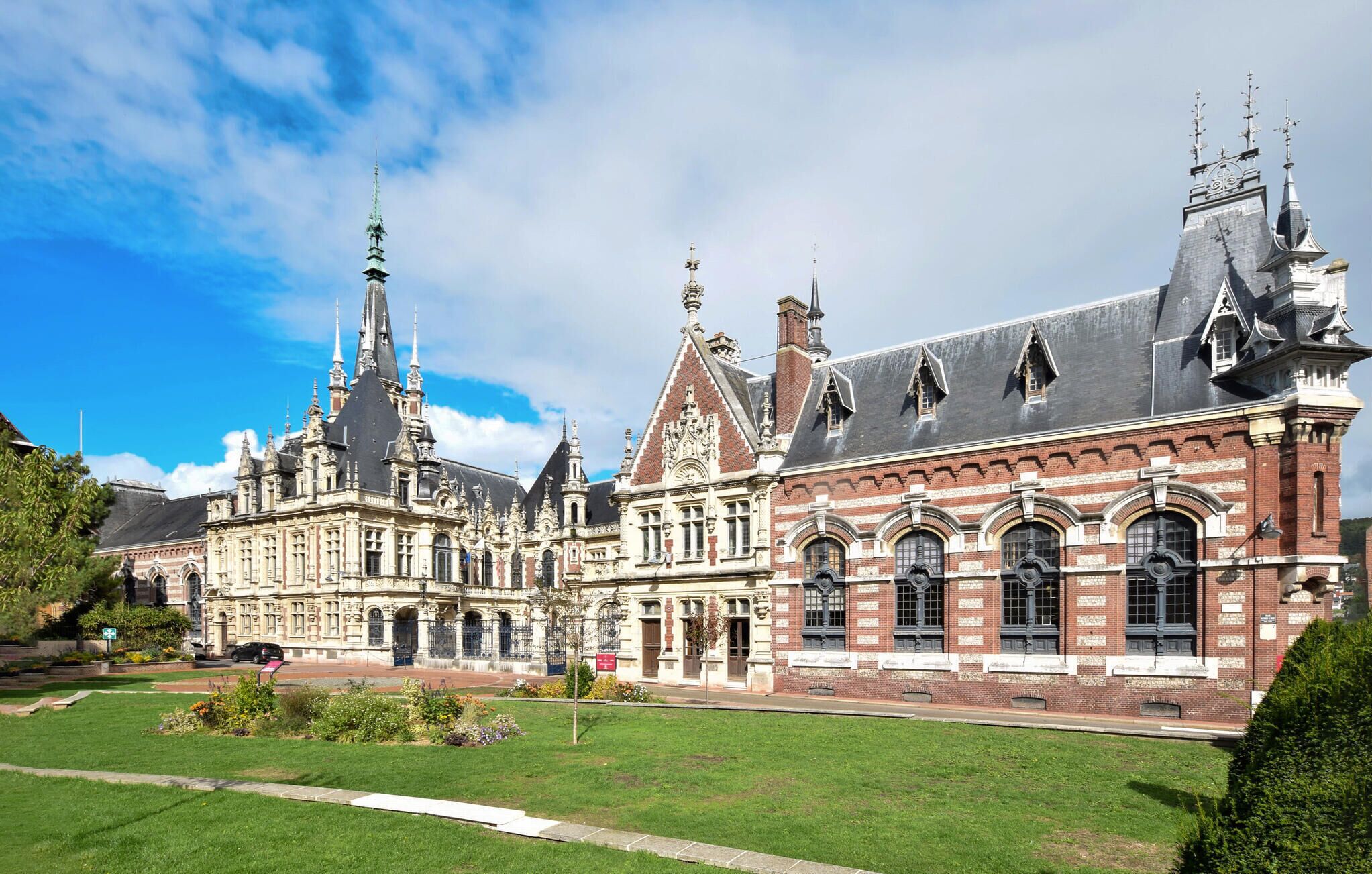 A historic building with ornate architecture, including multiple spires and a large central tower.