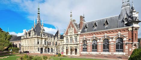 A historic building with ornate architecture, including multiple spires and a large central tower.