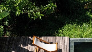 A wooden deck with two lounge chairs and a pool. - Scarlet Pavilion Homestay (Hue)