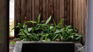A wooden fence with a rectangular water feature in front. - Scarlet Pavilion Homestay (Hue)