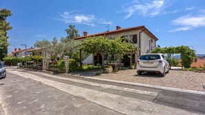 A residential area with a two-story house, a parked car, and a clear sky. - Apt Smode With Panoramic Balcony (Koper)