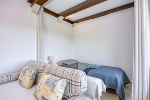 A bedroom with a bed, a sofa, and a nightstand. - Apt Smode With Panoramic Balcony (Koper)