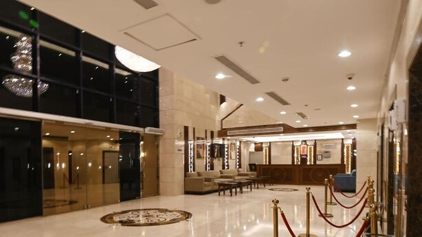 A spacious lobby with a reception desk, seating area, and a decorative floor pattern. - Retaj Inn Hotel (Makkah)