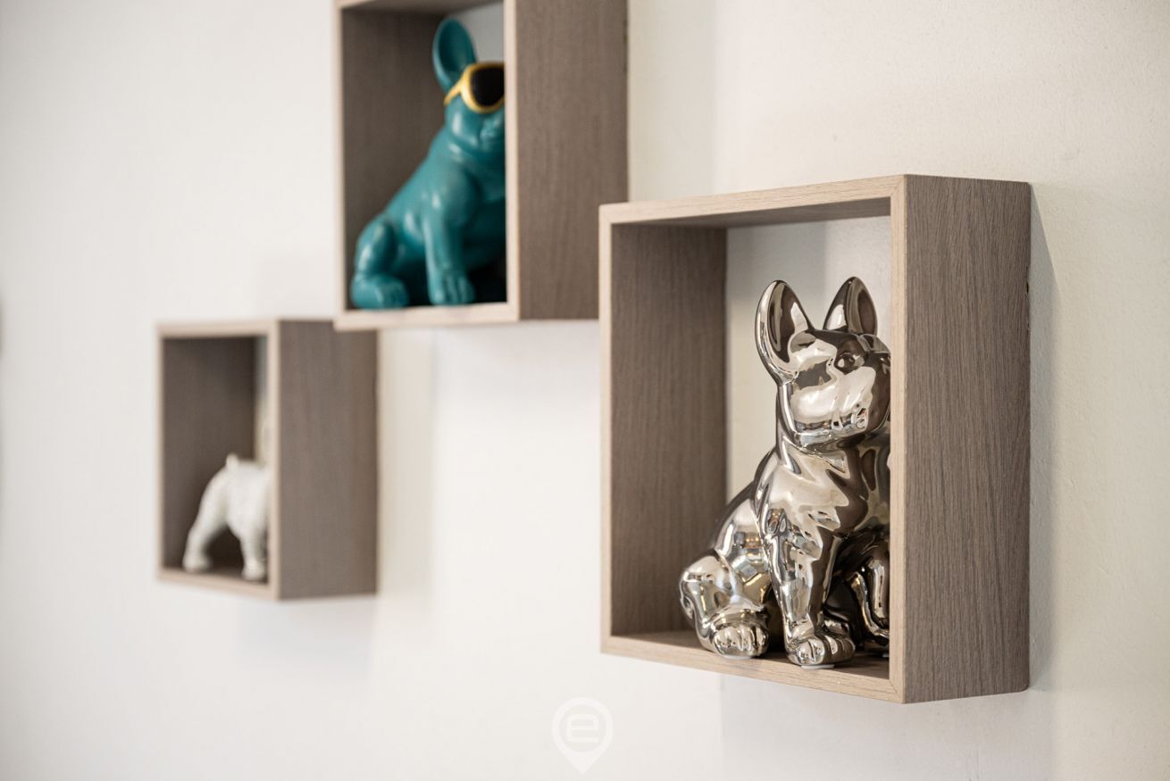 Three wooden display shelves with animal figurines.