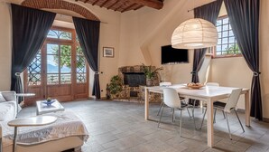 A spacious living area with a fireplace, dining table, and comfortable seating.