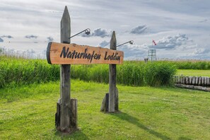 A wooden signpost with the text 'Naturschutzgebiet Loddin' in a natural setting. - Welcome to Störtebekers Reethus - your exclusive vacation home on Usedom (Loddin)
