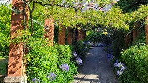 A garden pathway with brick pillars and lush greenery. - Spacious 3P in quiet palace, sea view in Menton (Menton)