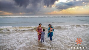 A beach scene with a stormy sky and waves. - Zostel Chennai Anna Nagar (Chennai)