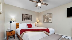 A neatly arranged bedroom with a bed, bedside tables, a ceiling fan, and wall-mounted artwork. - Tanners Ridge 37  with Wintergreen Advantage (Wintergreen)