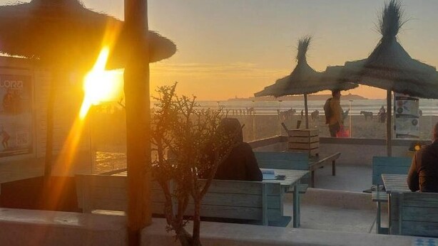 A beachside café with outdoor seating and umbrellas, overlooking the ocean. - Casadelmar (Essaouira)