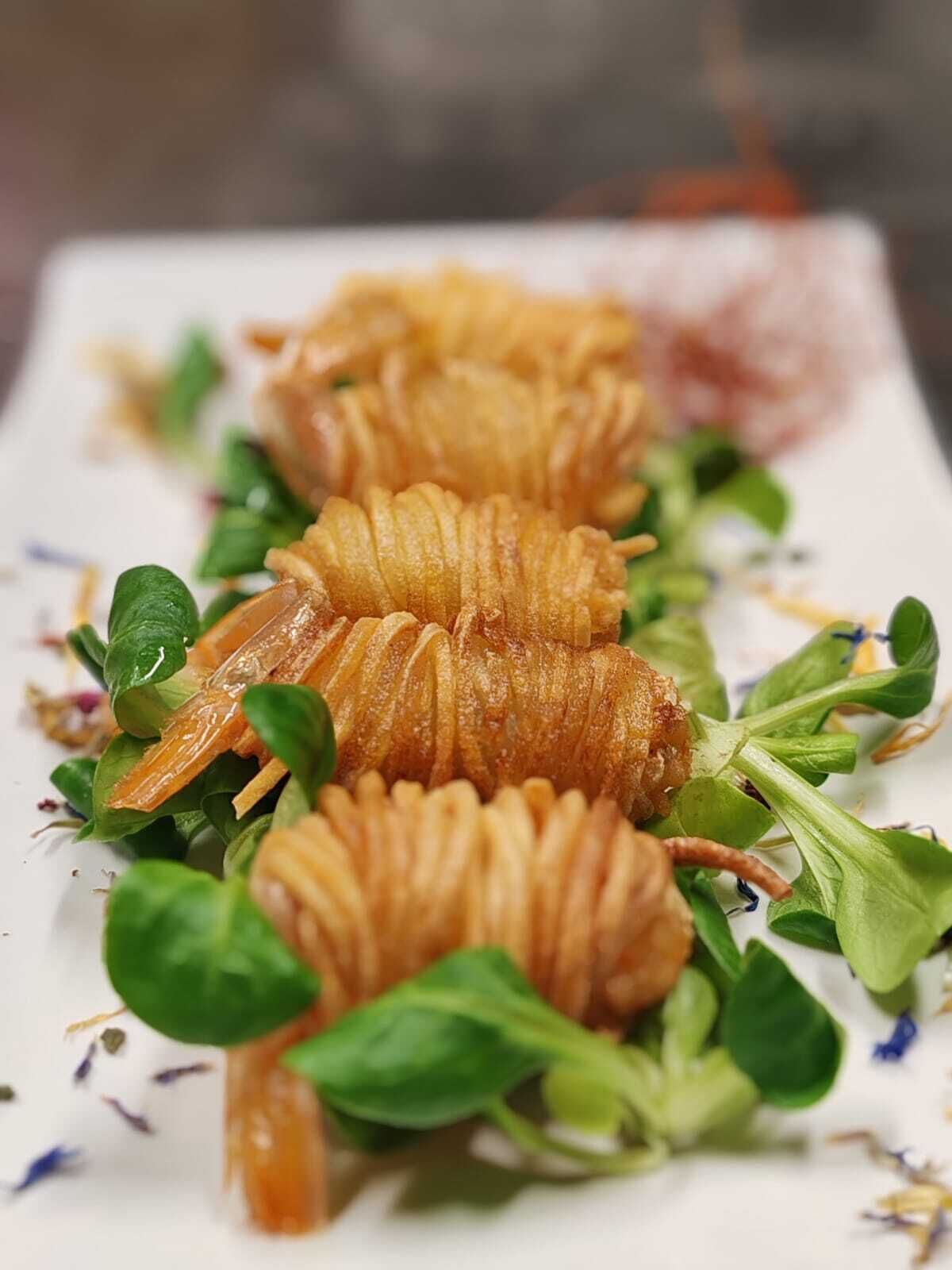 A plate of food with a decorative arrangement of leaves and a garnish.