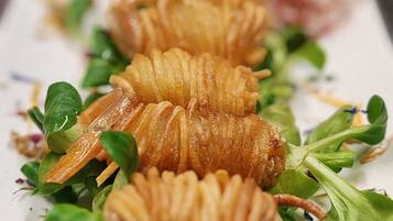 A plate of food with a decorative arrangement of leaves and a garnish.