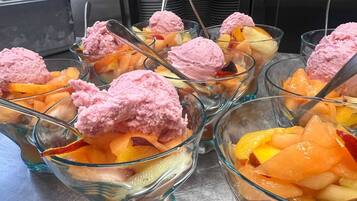 Dessert cups with pink ice cream and fruit.