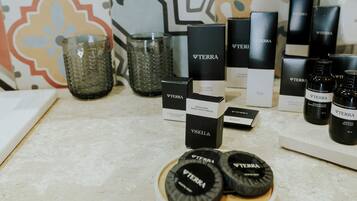 A countertop with various Terra brand products, including bottles and boxes, set against a colorful tiled backsplash.
