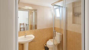 Ein modernes Badezimmer mit Duschkabine aus Glas, Waschbecken und Toilette.