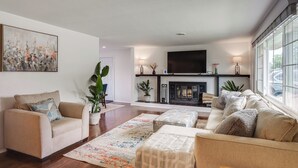A modern living room with a sofa, armchair, and a fireplace. - Dayton Family Home w/ Game Room: Walk to City Park (Dayton)