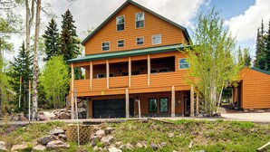 A two-story log cabin with a green roof, multiple windows, and a garage. - Brian Head Cabin < 1 Mi to Resort: Ski + Mtn Bike (Brian Head)
