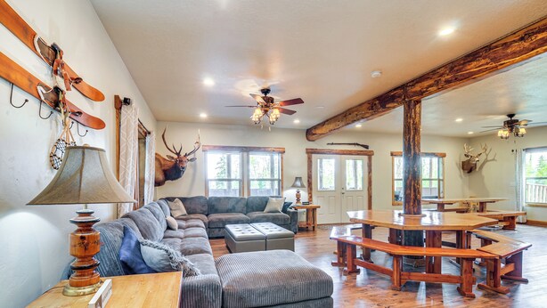 A spacious living area with a large sectional sofa, wooden tables, and a ceiling fan. - Brian Head Cabin < 1 Mi to Resort: Ski + Mtn Bike (Brian Head)